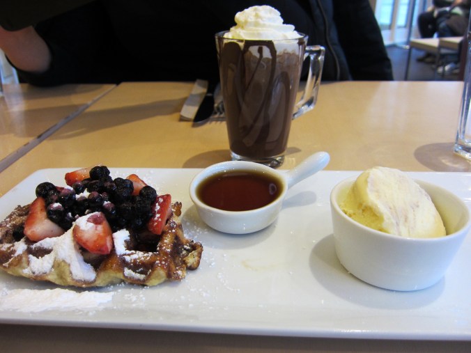 Maple syrup waffle - waffle topped with blueberries and strawberries, served with vanilla ice cream and maple syrup 